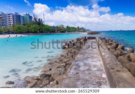 MALE\', MALDIVES - MARCH 7, 2015: Locals and tourists relax on city beach. This is the only artificial beach in Maldives.