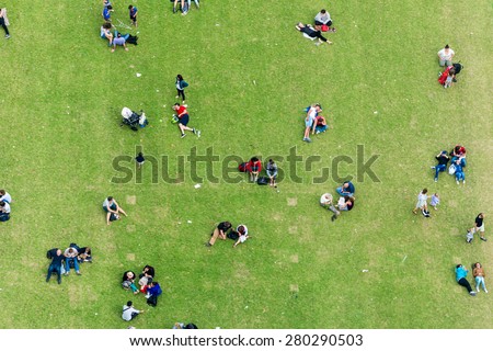 Ninety degrees view of people relaxing on a meadow.