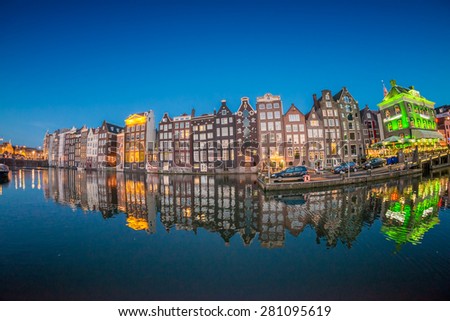Beautiful night skyline of Amsterdam. City homes along canal.