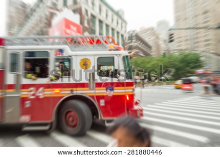 Blurred fast moving firefighters truck in New York City.