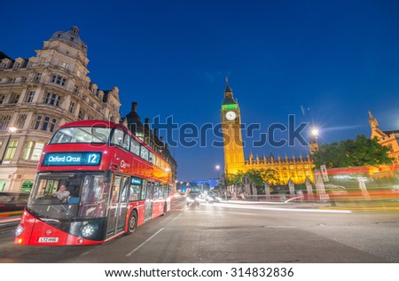 LONDON - JULY 1, 2015: Double Decker bus near Big Ben at night. The typical red bus is a famous tourist attraction.