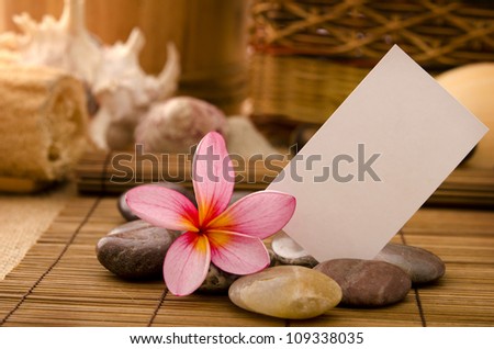 tropical spa with frangipani flowers arrangement and blank card for ads purpose