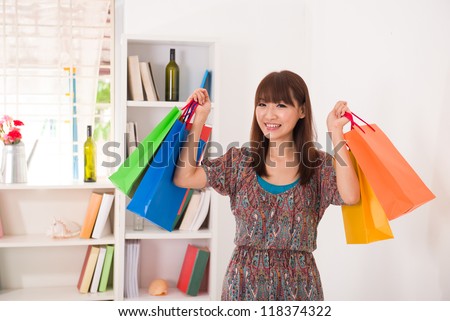 asian girl coming back from a shopping fair