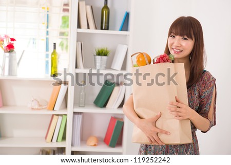 asian girl coming back from a shopping