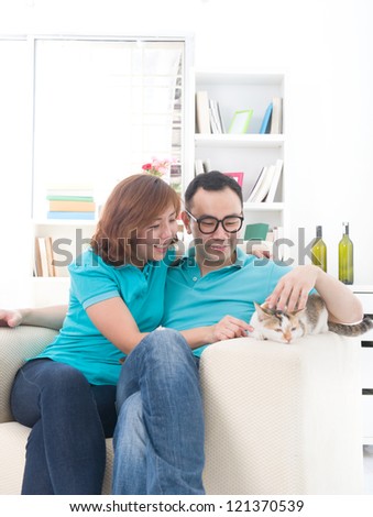 asian couple with cat	,  chinese south east asian ethnicity