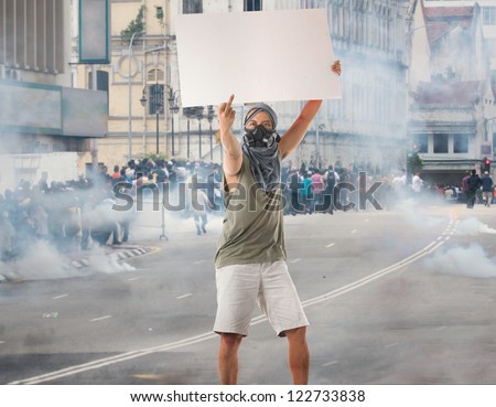 man in street protest with blank cardboard, looks great for advertistment with attitude