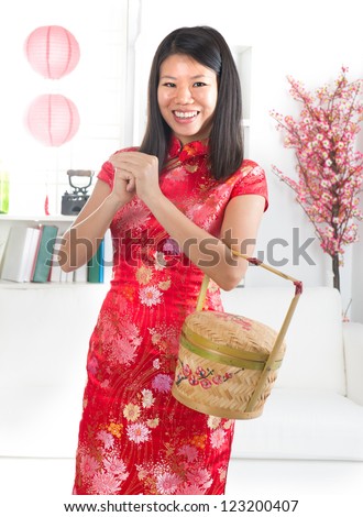 chinese new year girl with chinese greeting, with decorations on background