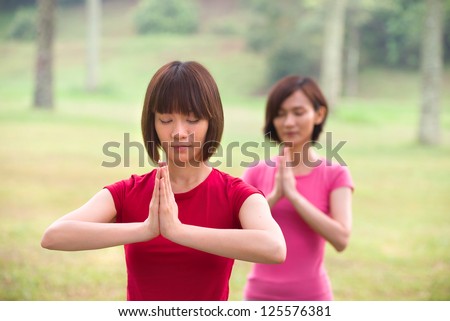 asian girls performing yoga outdoor