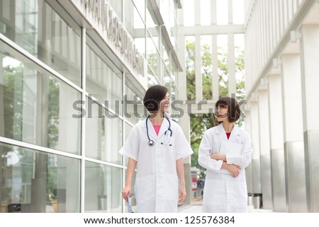 south east asian female doctors walking