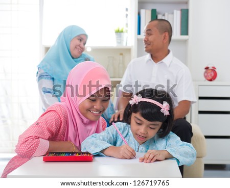 indonesian malay family doing homework together, quality time