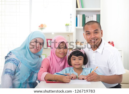 indonesian malay family doing homework together, quality time