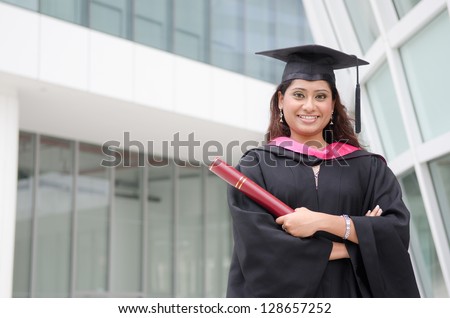 young indian female graduate with campus background