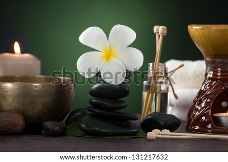 tropical frangipani spa health treatment with aroma therapy and hot stones, shot with ambient lights