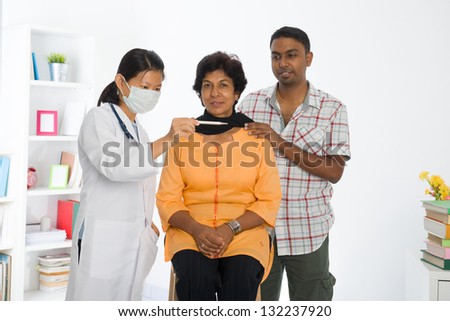 indian senior citizen health check with a chinese female doctor at hospital