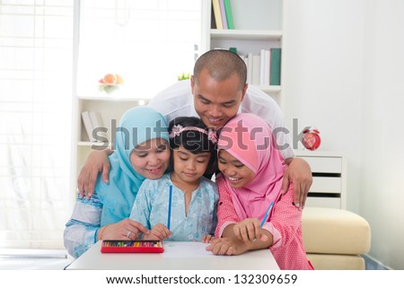 malaysian family doing homework together with lifestyle background at home