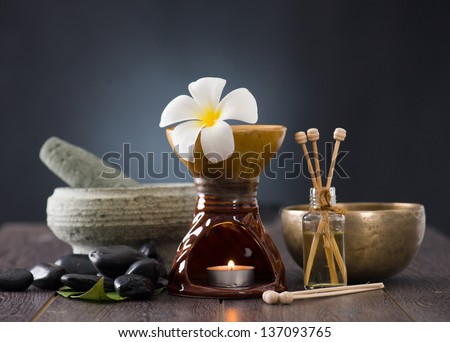 tropical frangipani spa health treatment with aroma therapy and hot stones, shot with ambient lights