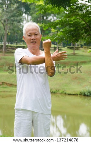 Retired Asian chinese senior man exercising in park