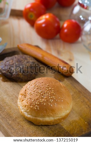 making hamburger fast food ingredients with plenty of raw materials on the background