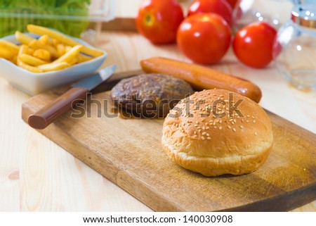 hamburger fast food ingredients with plenty of raw materials on the background