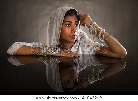 Beautiful young indian woman in traditional clothing .Gorgeous brunette traditionally dressed in deep thought