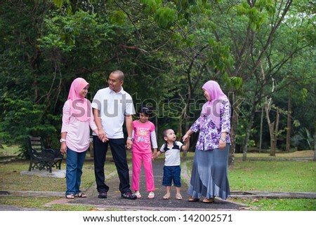 Malay family enjoying quality time outdoor at the park