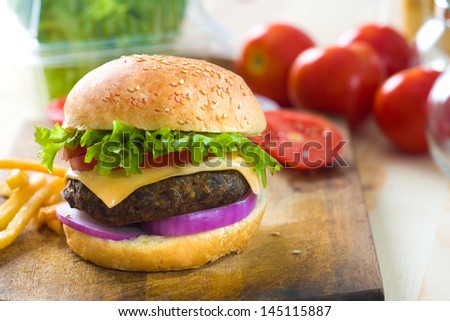hamburger fast food with plenty of raw materials on the background