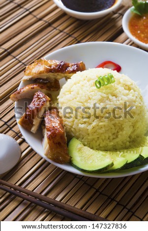 singapore chicken rice , traditional singaporean food with items as background