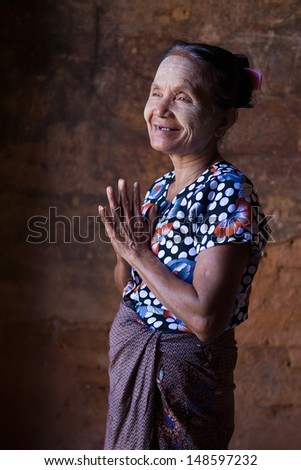 happy senior asian burmese woman in bagan with greetings