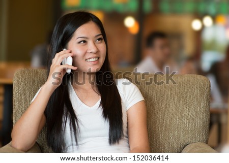 asian girl lifestyle on phone while enjoying coffee in cafe