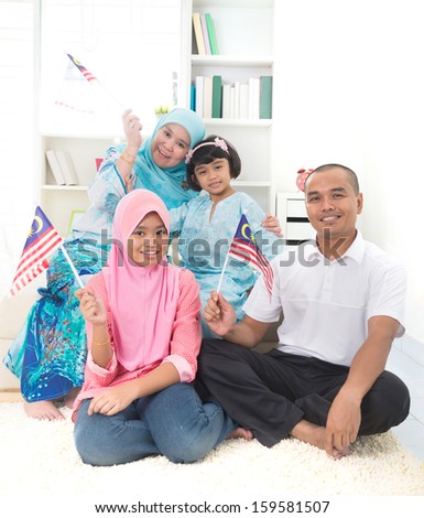 malay family with malaysian flag lifestyle photo