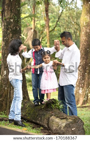 indian family teaching children to climb