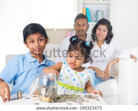 indian parent teaching children on savings and financial planning