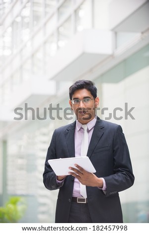 indian business male with a tablet