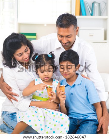 indian family enjoying eating ice cream indoor