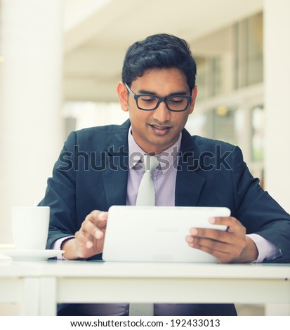 india business man on a tablet computer with vintage filter