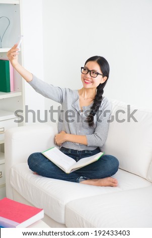 happy woman using tablet pc on sofa in the living room,