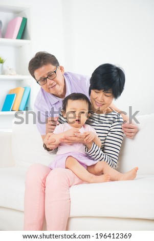 asian grand parents with grand daugther with life style background