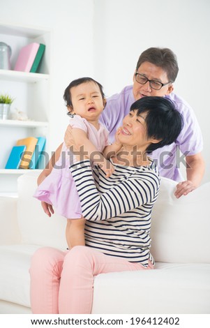 asian grand parents with crying grand daugther