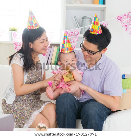 asian baby with family celebrating baby birthday party