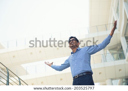 successful indian business man expressing in office outdoor