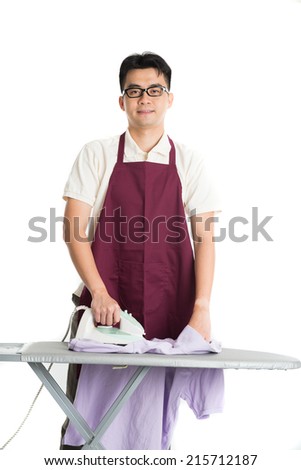 asian chinese male iron shirt and doing laundry work