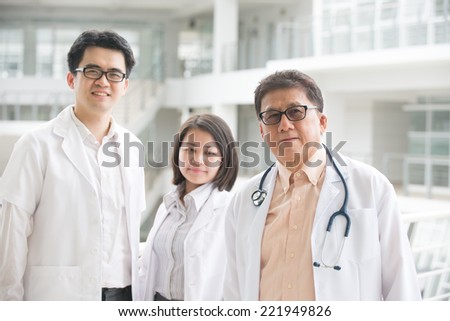 Asian medical team of doctors standing inside hospital building