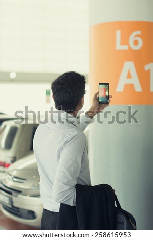 indian male take photo after parking at car park
