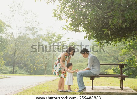 Happy Asian Family enjoying their time in the park