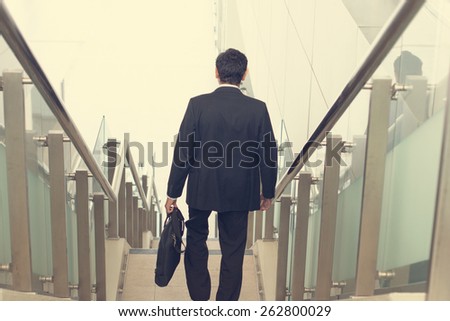 indian business male walking on stairs