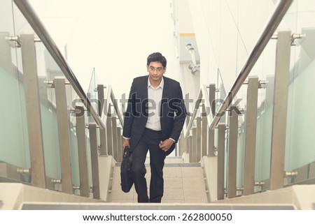 indian business male walking on stairs