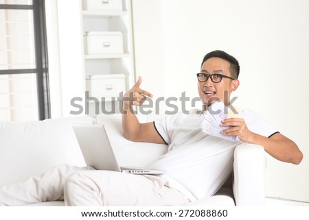 asian male enjoying cash back credit card
