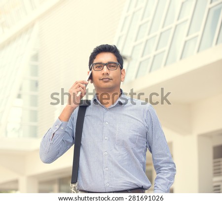 indian business male on a phone outdoor
