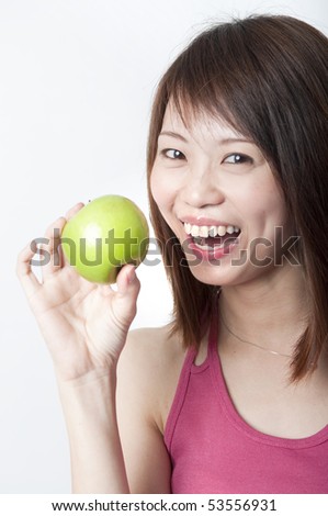 healthy young asian smiling with a green apply