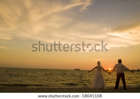 couple holding hands in sunset. asian couple holding hands